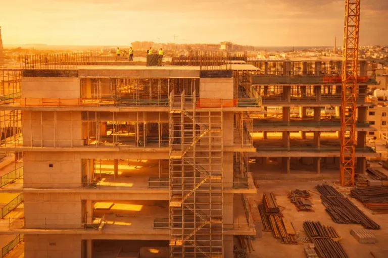 Steel fixers installing reinforcement bars at a large construction site in the UAE for reinforced concrete structure construction